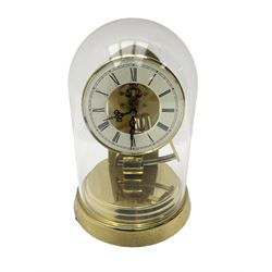  A late 20th century -  German Kieninger & Obergfell, “Kundo” battery operated
mantle clock under an acrylic shade, with an electrically operated solenoid pendulum housed on a circular brass base, skeleton movement with visible motion work through a painted 4-1/2” open chapter ring, with pierced steel hands, Roman numerals and minute track.