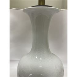 Pair of Chinese ivory crackle glazed table lamps, each of bottle form, raised upon circular hardwood base, excluding fittings H43cm