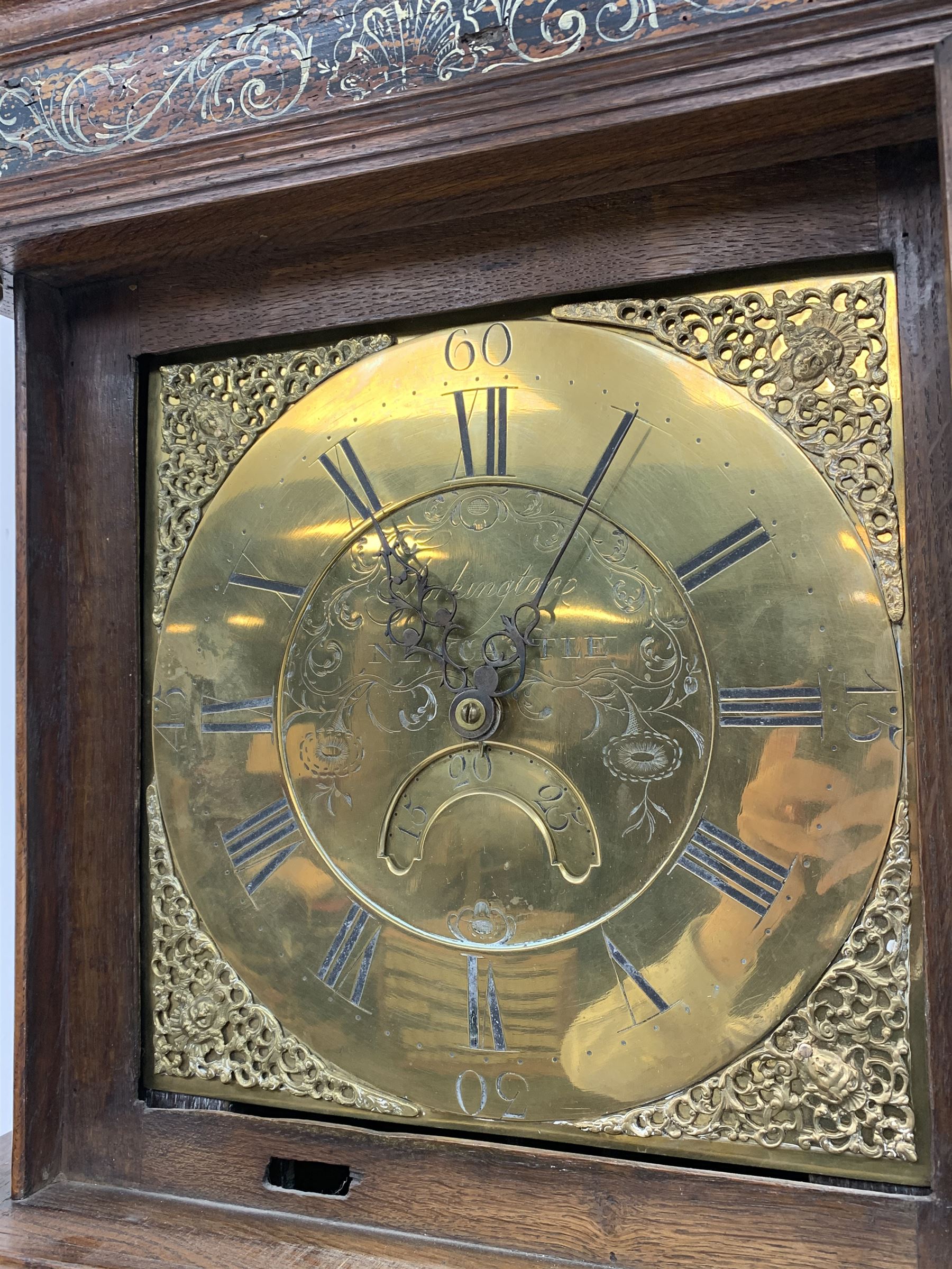 Early 19th century oak longcase clock, projecting cornice over frieze painted with scrolls, square glazed door enclosed by plain pilasters, square brass dial with ornate cast metal spandrels, Roman chapter ring and false subsidiary date aperture, engraved decoration and inscribed 'Torkington, Newcastle', 30-hour movement striking on bell
