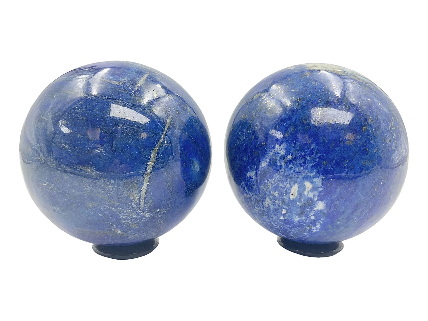 Pair of Lapis lazuli spheres, upon a carved stone stands, D8cm