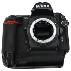 Nikon D2x digital SLR camera body, serial no. 5020627, with some associated battery packs and accessories