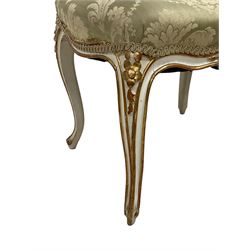 20th century French design parcel gilt and painted dressing table stool, upholstered in sage green damask fabric, shaped form on floral carved cabriole supports, with matching cushion 