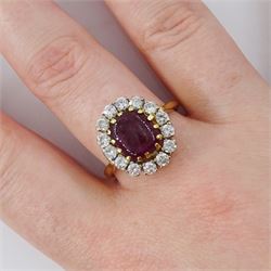 18ct gold garnet and diamond cluster ring, single cabochon cut garnet surrounded by twelve brilliant cut diamonds, London 1970, total diamond weight approx 0.60 carat 