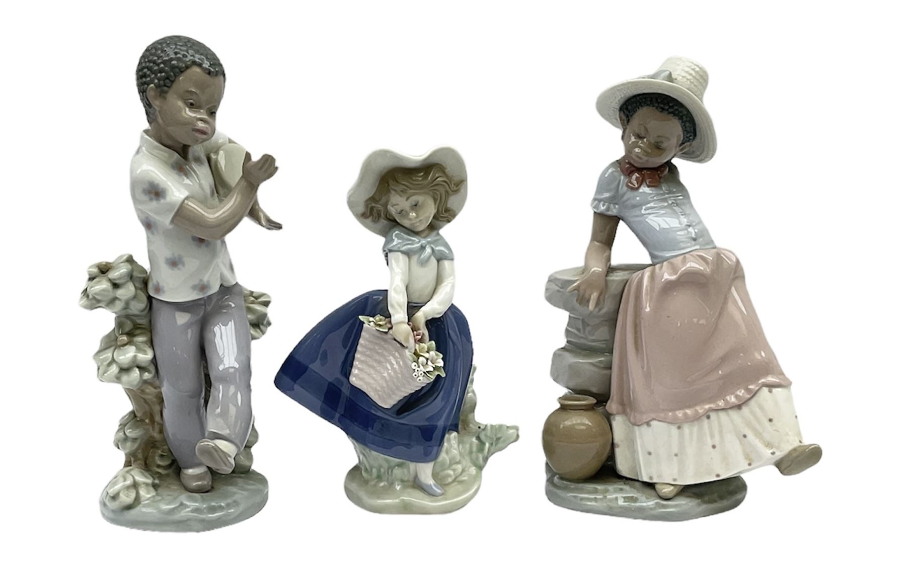 Pair of Lladro figures designed by Jose Roig, Bongo Beat no. 5157 and A Step in Time no. 5158 and a Lladro figure of a girl with a basket of flowers.
