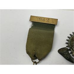 Made-up group of three WWI medals comprising 1914 Star awarded to 23598 Gnr. F. Jefferson R.G.A., British War Medal and Victory Medal with names removed; with ribbons on wearing bar; 1942 Motorist's Medal and small quantity of cap badges, Royalty badges etc