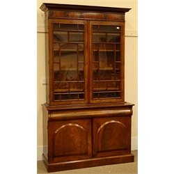  Victorian figured mahogany bookcase on cupboard, projecting cornice, two astragal glazed doors enclosing four adjustable shelves, above single moulded frieze drawer, two cupboard doors, plinth base, W134cm, H230cm, D50cm  
