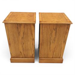 Pair of burr oak bedside tables with campaign brass handles, inlaid and crossbanded top, above four graduating drawers with cockbeaded edges, raised on a plinth base 