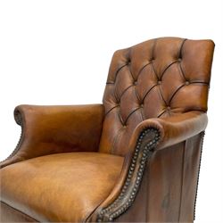 Laura Ashley - hardwood-framed armchair, traditional shape with arched cresting rail over rolled arms, upholstered in buttoned brown leather with studded work, on turned front feet (W76cm, W95cm, D84cm); together with matching rectangular footstool (53cm x 34cm, H29cm)
