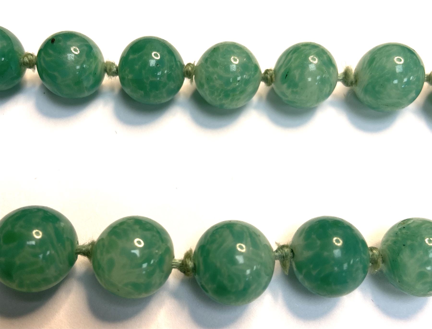 Chinese jade bead necklace with silver open work clasp with a cabochon greenstone/possibly jade bead necklace, signed Liu with Chinese character marks