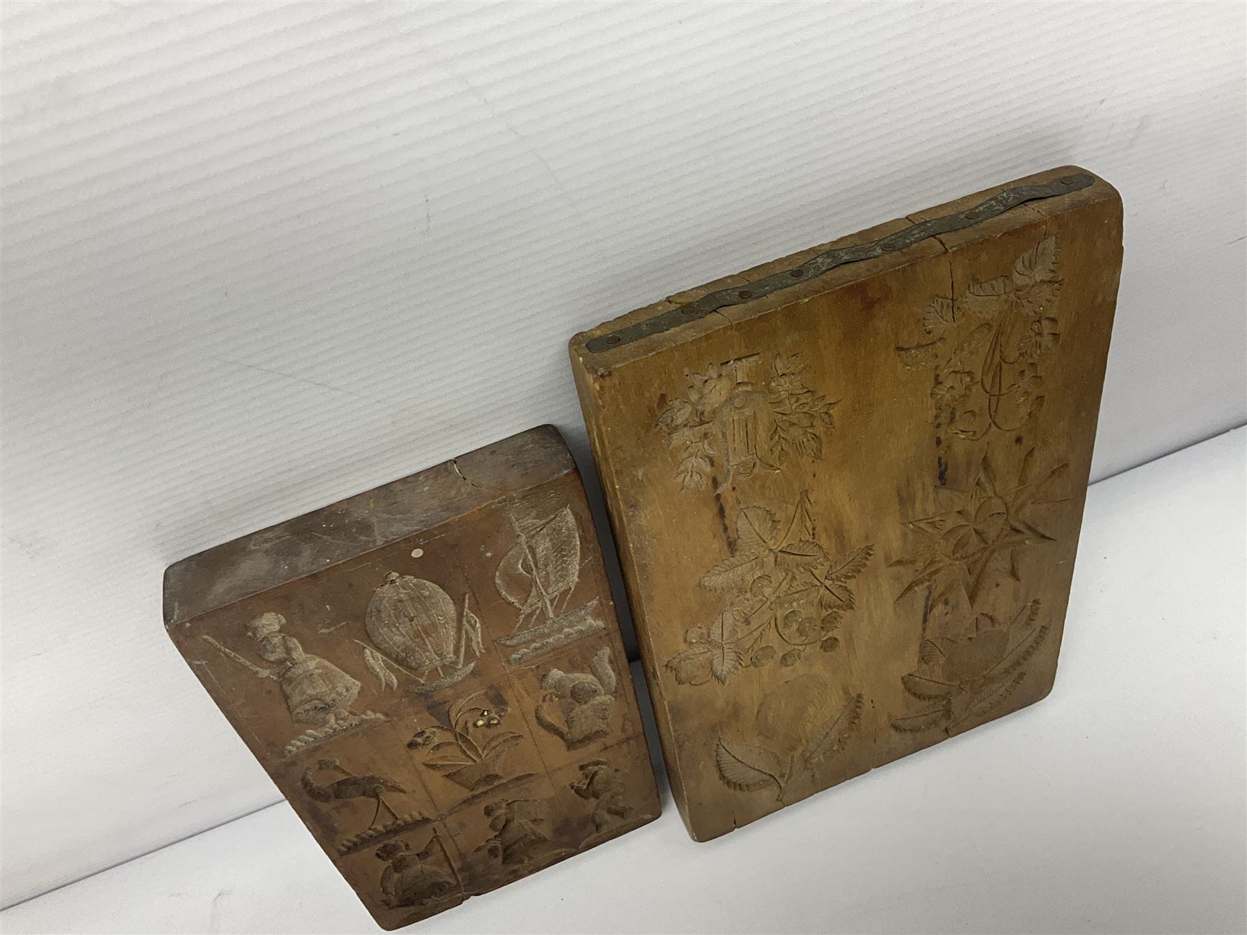 Two wooden biscuit moulds, carved loving spoon and fork, and two bradawls 