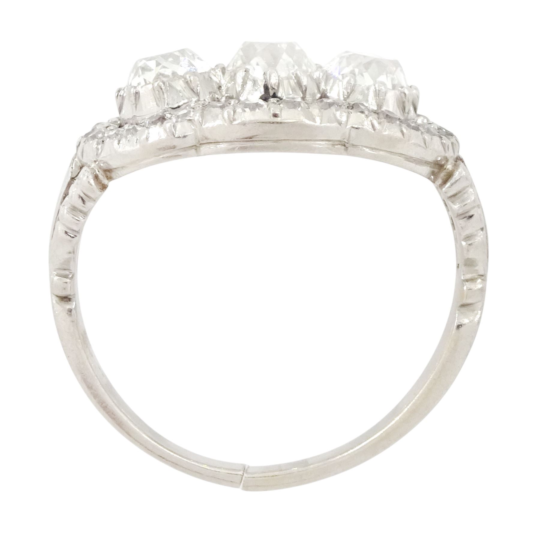 Late 19th / early 20th century platinum diamond ring, three old cut diamonds, in an openwork setting surrounded by further old cut diamonds, with pierced design shoulders, principal three diamonds total weight approx 1.45 carat, in a velvet and silk lined box by Selfridges