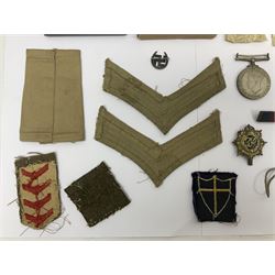 WWII group of three medals comprising 1939-45 War Medal and Italy and Africa Stars in issue box; dog tags for 282894 W. Wilkinson with framed photograph in uniform; and small quantity of cloth and metal badges including RAOC cap badge