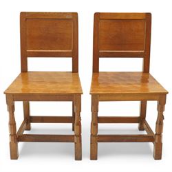 Mouseman - pair of oak panel back side chairs, adzed panel back and seat, on octagonal sup...