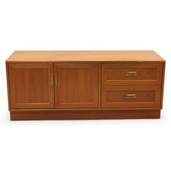 G Plan - 'Fresco' teak side unit, rectangular top above twin cupboard doors and two drawers, drawers fitted with cassette tape storage and a fall front drawer, raised on a plinth base