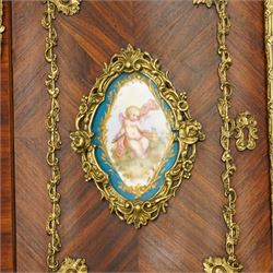 Pair of late 19th to early 20th century Kingwood and ormolu mounted encoignure or wall hanging corner cabinets, shaped end supports with mirror backs, serpentine double cupboard mounted by sevres design porcelain panels, decorated with foliate cast metal mounts, the interior fitted with shelf