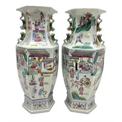 Pair 20th century chinese vases, of hexagonal baluster form,  with applied twin temple lion handles to the waisted neck , the body decorated with village scenes, with a blossoming foliage boarder to the base, H43cm  
