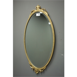  19th century mahogany framed mirror carved gilt foliate, (51cm x 73cm), and a small oval bevel edged wall mirror with gilt frame, (35cm x 67cm)  