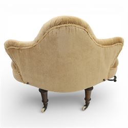 20th century pair of bedroom chairs upholstered in buttoned taupe velour, each of slipper chair form with low wraparound back and deep seat, the backs button tufted with padded wings, raised on turned front supports with castors