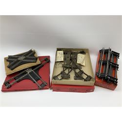 Hornby '0' gauge - layout accessories comprising PR1/PL1 Points, CR1 Right Angle Crossing and CA2 Acute Angle Crossing, all boxed; tin-plate signal box; tin-plate level crossing; textured wooden tunnel, possibly pre-WW2; and quantity of track, some boxed; together with '00' gauge tin-plate station