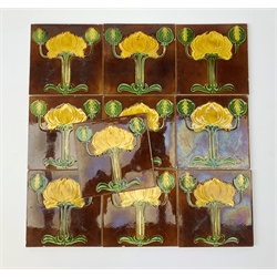 Ten Art Nouveau tiles, each decorated with stylised yellow and green flowers upon a brown ground,15cm x 15cm. 