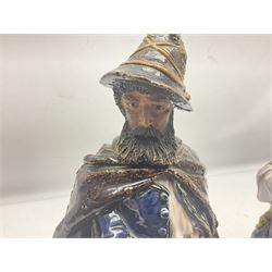 Pair of late 19th century continental glazed stoneware Black Forest style figures, H33cm