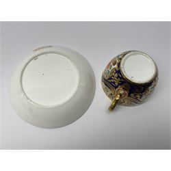 Early 19th century Spode teacup and saucer, decorated in pattern no 1216, the Imari pallet interspersed with circular panels containing a crest of arm holding a scimitar, saucer H5.5cm, saucer D13.5cm