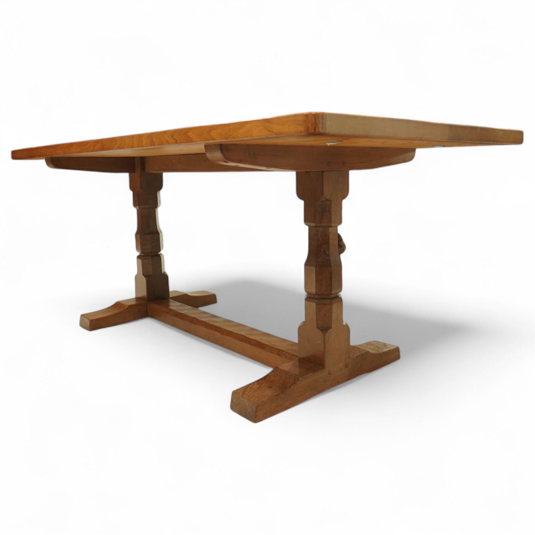 Mouseman - adzed oak 6’ refectory dining table, rectangular top with visible dowel pegs and adzed surface, raised on octagonal carved supports with stretcher and sledge feet, carved mouse signature to leg, by the workshop of Robert Thompson, Kilburn
