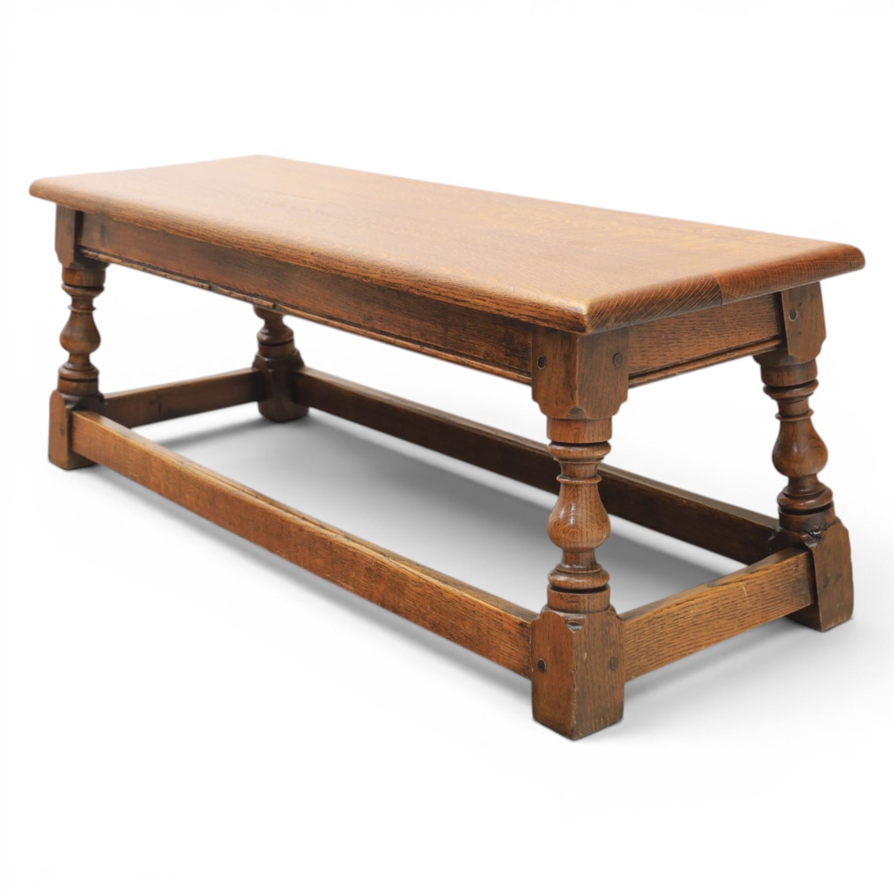 17th century style oak long joint stool, rectangular top with moulded edges, raised on turned supports united by stretchers