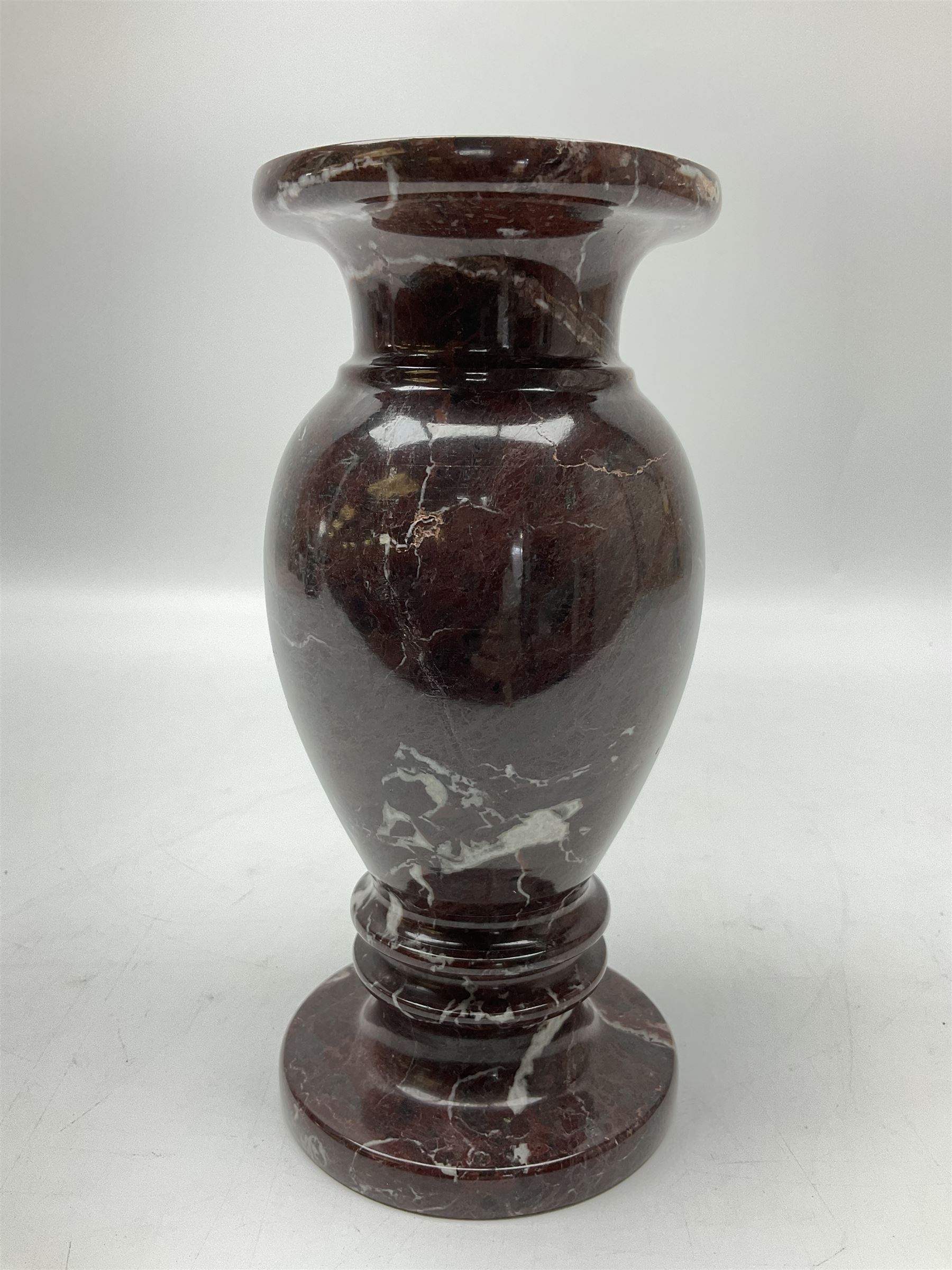 Red marble vase, of baluster form upon a stepped foot, H20cm 