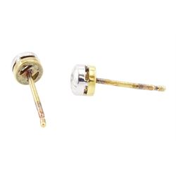 Pair of 18ct white and yellow gold diamond earrings, each stud bezel set with a round brilliant cut diamond, London 1998, total diamond weight 0.25 carat