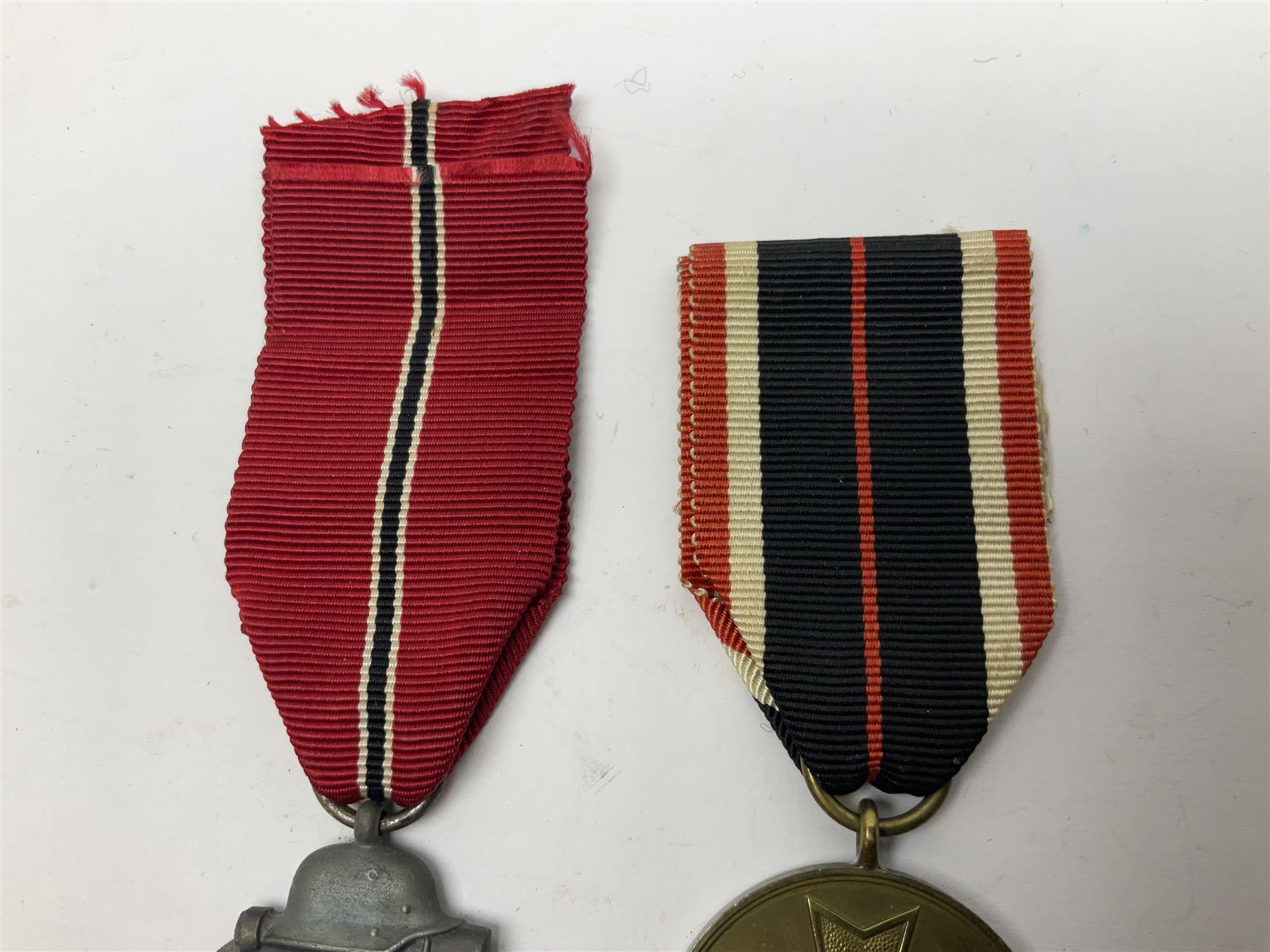 German War Merit Cross 1st Class, the pin-back stamped '50'; War Merit Medal; and Ostfront Medal for the Winter Campaign in Russia of 1941-1942 'Die Medaille Winterschlacht Im Osten'; all with ribbons (3)