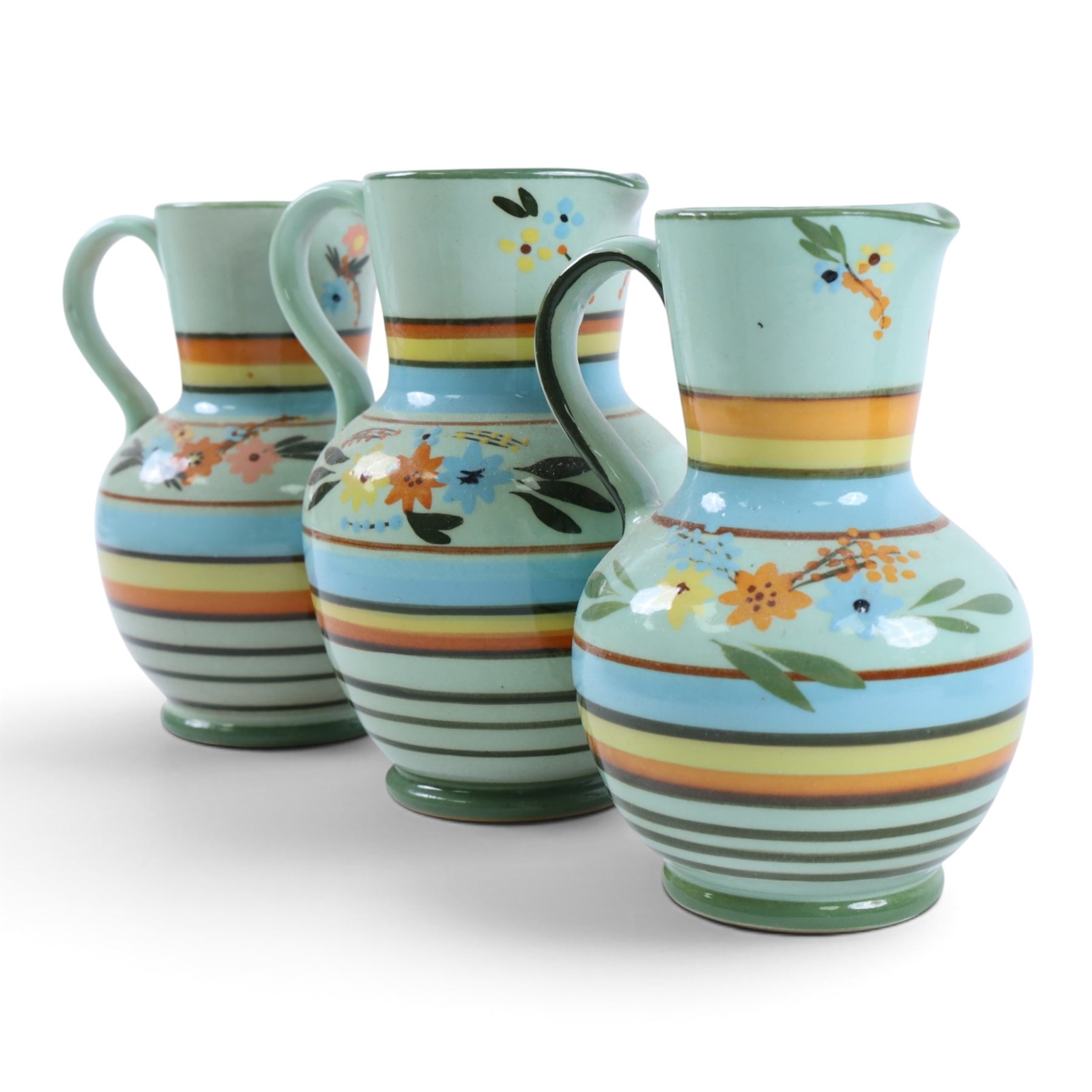 Hartrox Stoneware comprising three jugs, two vases and three bowls, all with green, blue and yellow floral decoration, with printed marks beneath, tallest H20cm