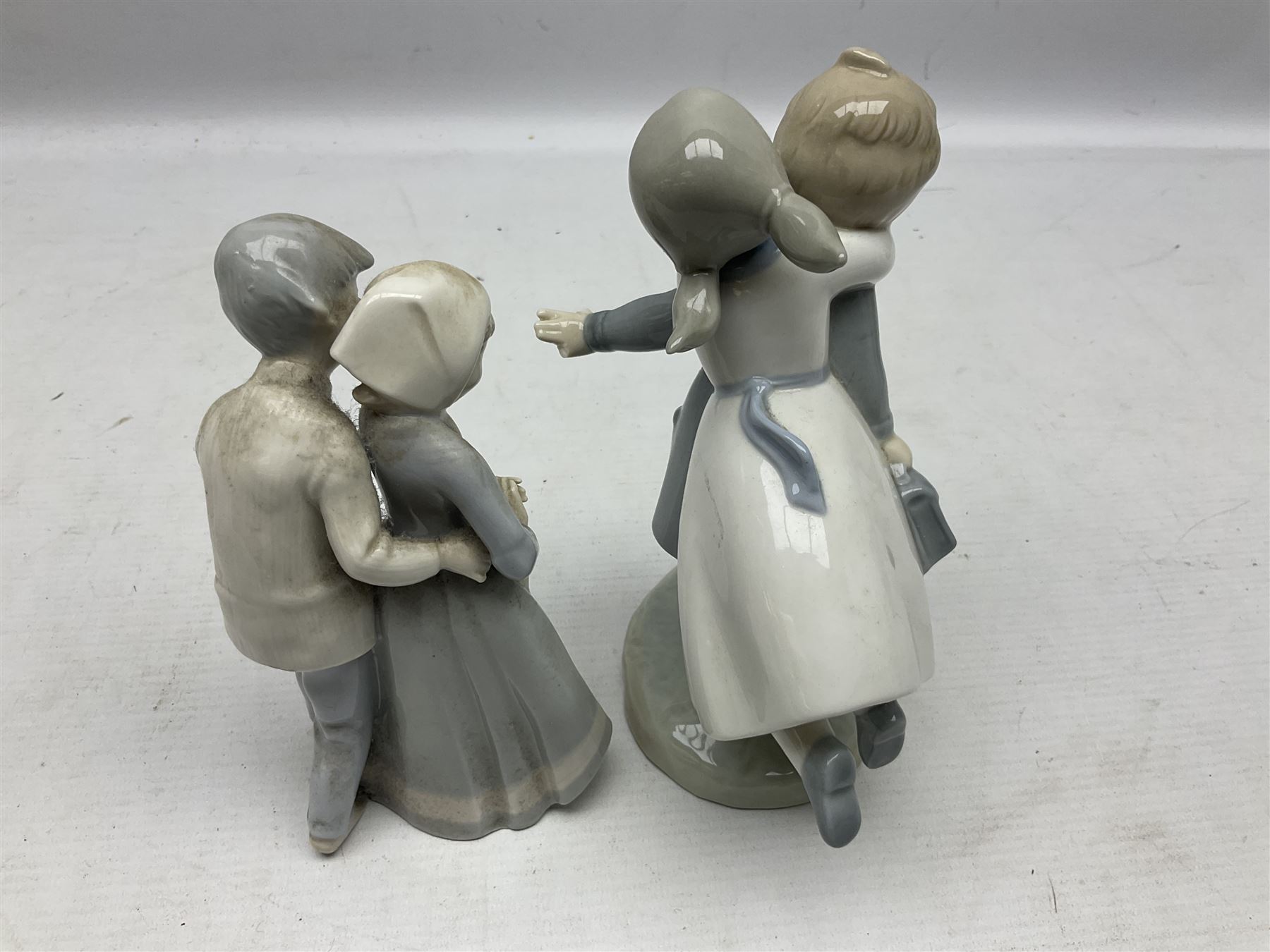 Three Nao figures comprising The Next Dance 1201 and Girls First Communion 0236, and young girl wearing a hat, together with two further Spanish style figures