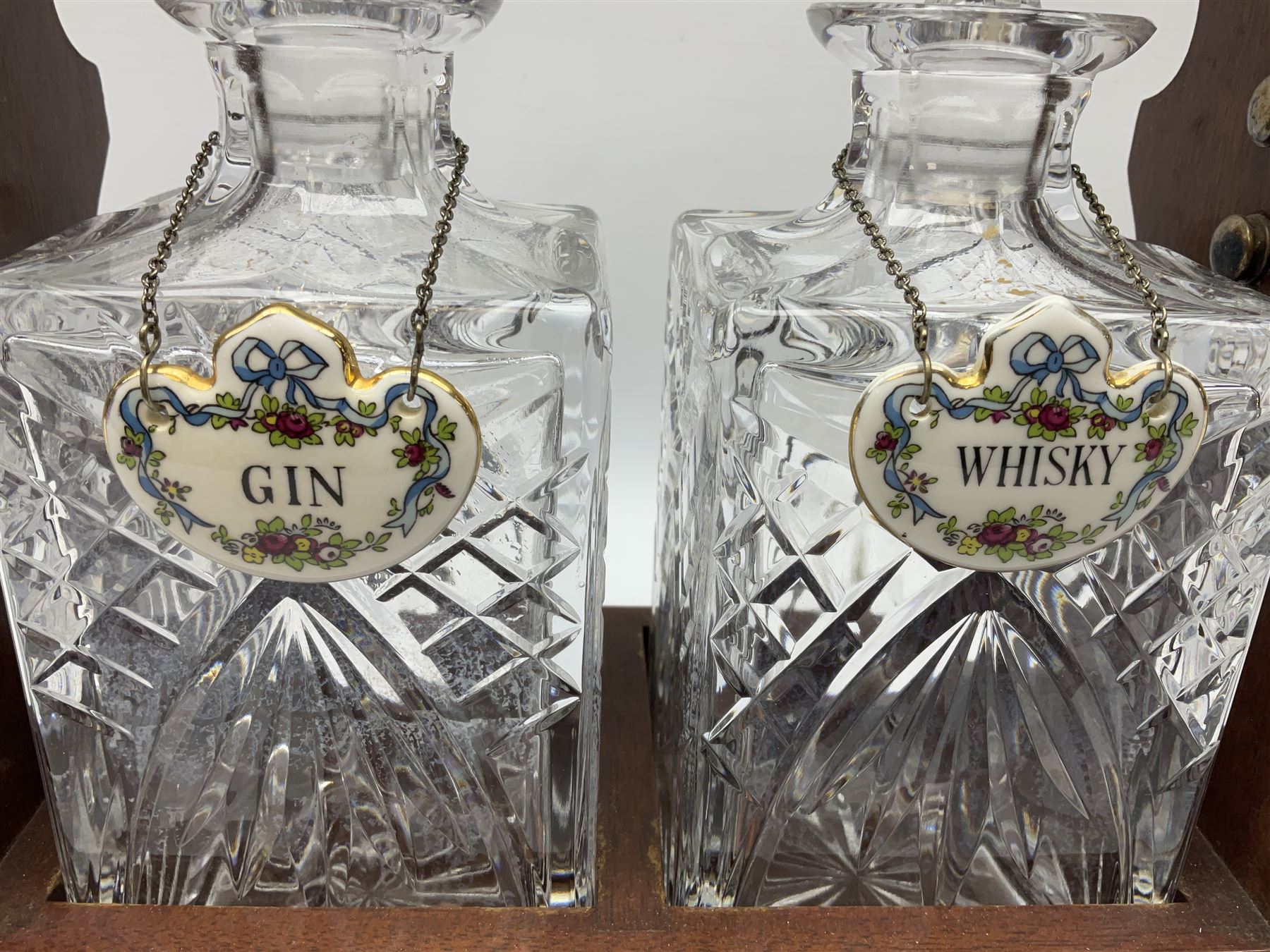 Late 20th century mahogany and silver plated two cut glass decanter tantalus, marked PB&S, with Whisky and Gin Crown Staffordshire ceramic decanter labels, H32cm