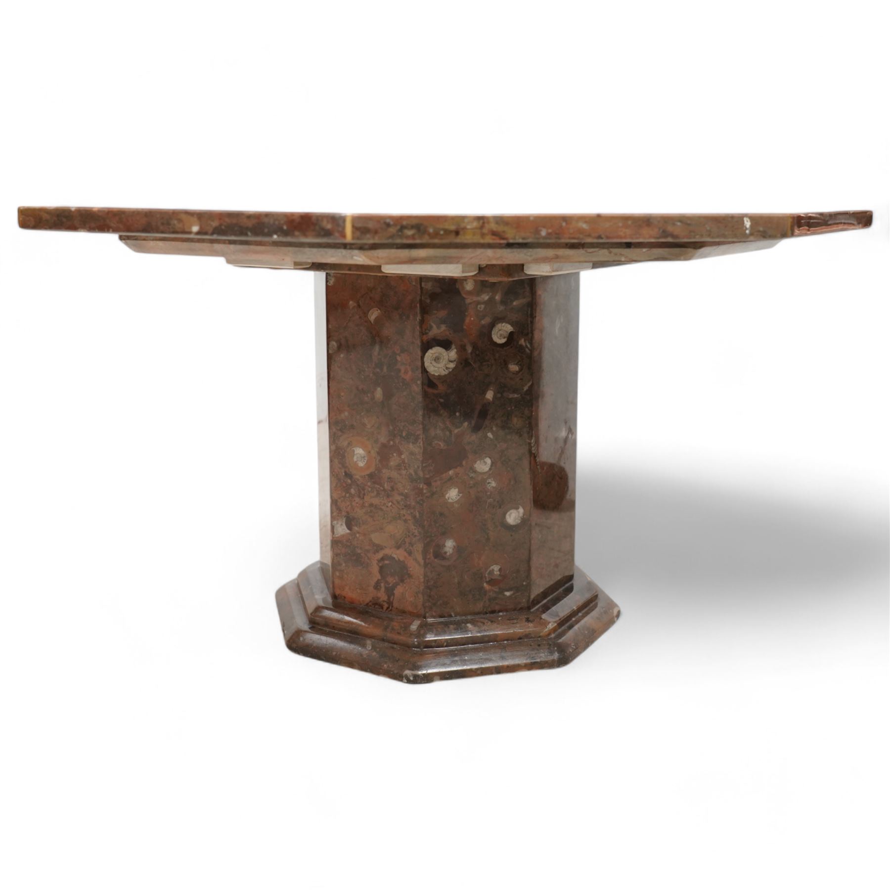Octagonal specimen table with brass inlay, the limestone tabletop with a central ammonite and orthoceras and goniatite inclusions, upon a stepped octagonal base 