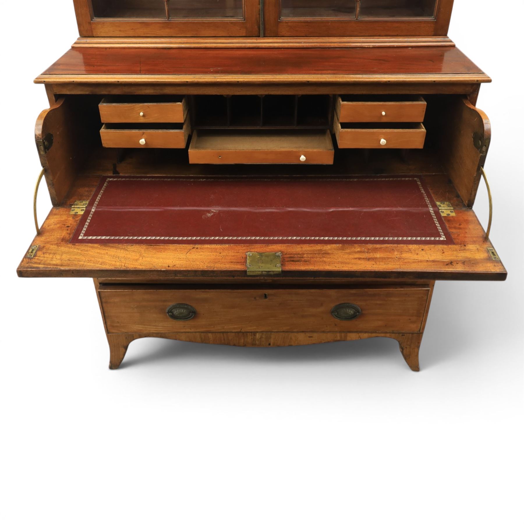 George III mahogany secretaire bookcase, the upper section with projecting cornice above astragal glazed doors, with three adjustable shelves, the lower section with secretaire drawer, fitted and with tooled leather writing surface, inlaid drawer fronts with brass handles, three graduating drawers below, raised on bracket feet