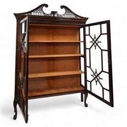 Large George III mahogany bookcase display cabinet, pierced swan neck pediment with floral head roundels over dentil and arcade frieze, enclosed by two geometric astragal glazed doors with lozenge motifs, the lined interior fitted with three shelves, gadrooned lower rail over acanthus carved cabriole supports with ball and claw feet 
