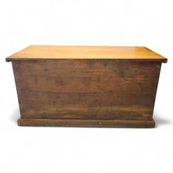 Burmese hardwood and brass inlaid marriage chest, the hinged top enclosing a fitted interior with small drawers, the front decorated with a circular brass medallion, raised on a plinth base