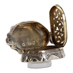 Victorian silver vinaigrette, of oval form with shaped edge, decorated throughout with engine turned bands, the hinged cover with vacant C scroll panel opening to reveal a foliate pierced grille and gilt interior, hallmarked George Unite, Birmingham 1857, L3.5cm