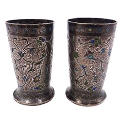 Pair of Indian or Persian silver and enamel tot glasses, of slightly tapering cylindrical form with foliate chased decoration, H6cm, approximate weight 3.03 ozt (94.3 grams)