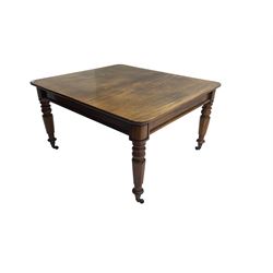 Late 19th century extending mahogany dining table, square top with banded frieze rail, raised on turned octagonal supports with  brass cups and castors, with two additional leaves