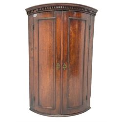 George III oak cylinder corner cupboard, dentil cornice over two doors enclosing three shelves