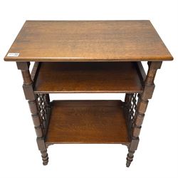Late 19th century oak three-tier stand or bookcase, on turned supports with lattice sides, on turned feet with castors