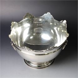 Edwardian silver Monteith punch bowl, the scalloped rim with strapwork and figural decoration, with two lion mask mounted ring handles, upon a circular stepped foot, hallmarked London 1903, maker's mark worn and indistinct, H15cm, D23cm