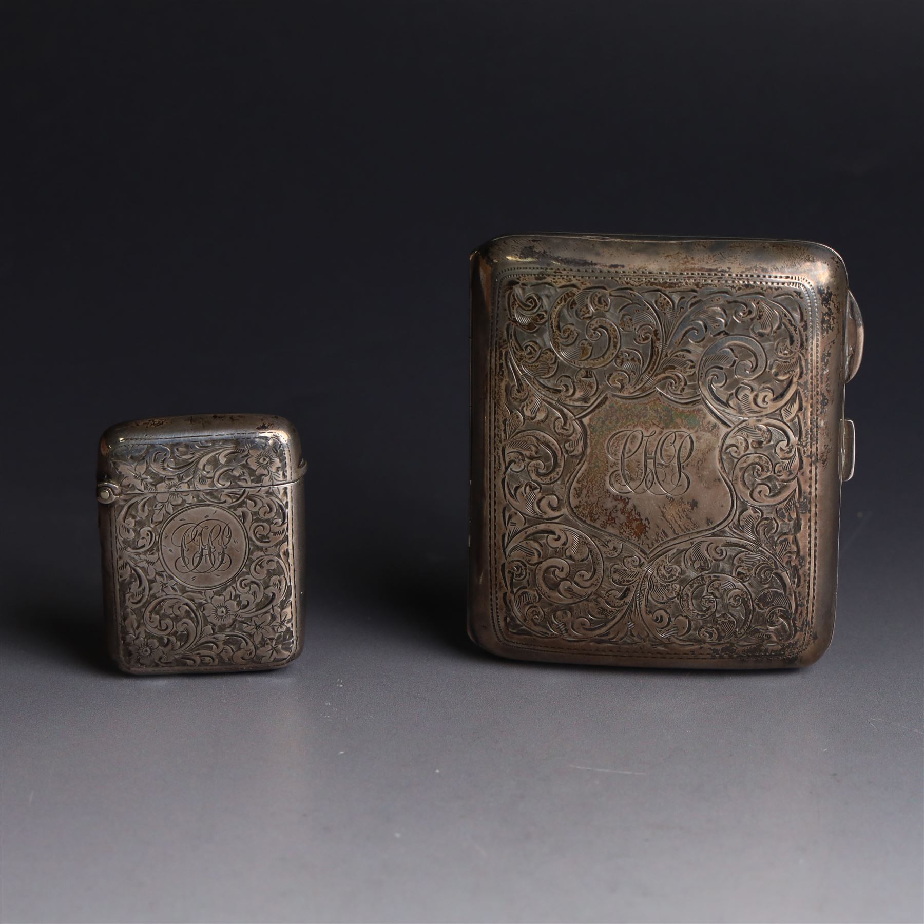 1920s silver cigarette case, with engraved initials and foliate decoration to cover and personal engraving to interior, hallmarked Smith & Bartlam, Birmingham 1924, with a similar silver vesta case, hallmarked, cigarette case H8.5cm
