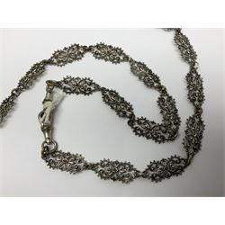 19th century continental silver plated chatelaine, the main body flanked with winged mythical beasts and central soldier slaying a dragon supporting three suspended items to include velvet lined small basket and long clasped filigree chain, together with a thimble