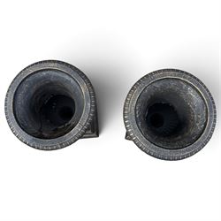 Pair of Neoclassical design black and gilt painted cast iron garden urns of campana form, with egg-and-dart rims and fluted bodies, on knopped stems, fluted socles and stepped square plinth bases