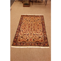  Kashan multicoloured rug, field with all over flower decoration on an ivory ground, blue repeating border, 188cm x 135cm  