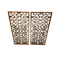 Pair 19th century Chinese lattice wall panels, in moulded frames with metal hangers, decorated with carved flower head