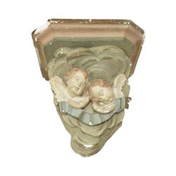 Set of three Belgian wall cornices, each with moulded shelf top above polychrome painted cherubic and rococo scroll ornament

Pale green (H 43cm, D 42cm, W 39cm)
Painted cherubs (H 51cm, D 47cm, W 49cm)
Darker green (H 46cm, D 42cm, W 50cm)